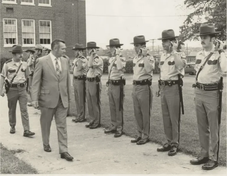Old image of Camillus Police Chief walking down a line of police officers doing an inspection